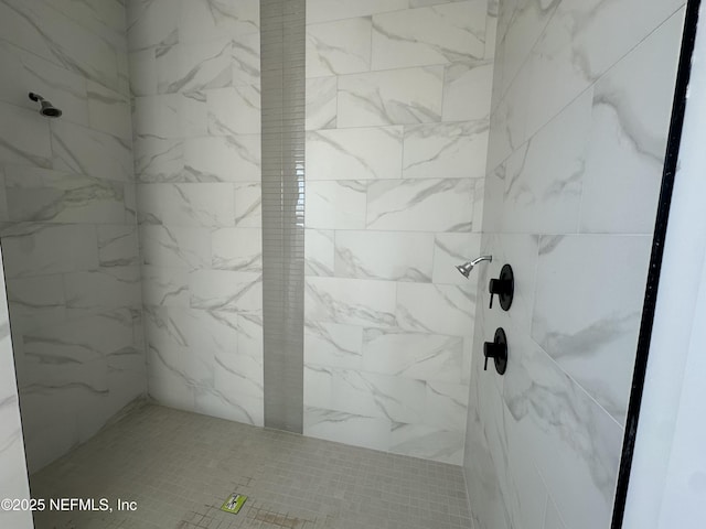 bathroom featuring a marble finish shower