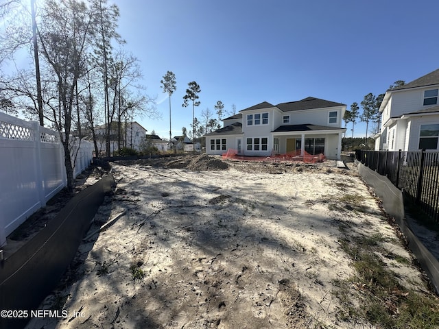 rear view of property featuring a fenced backyard