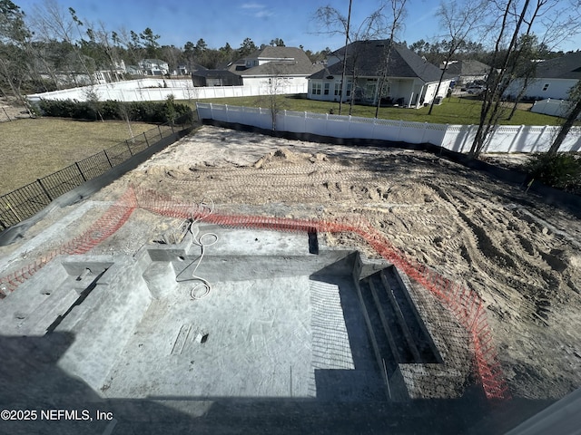 view of storm shelter featuring fence private yard and a yard