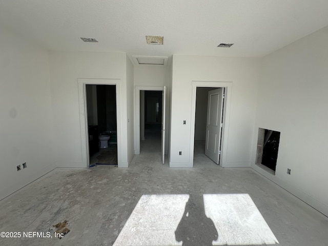 unfurnished bedroom with visible vents and attic access