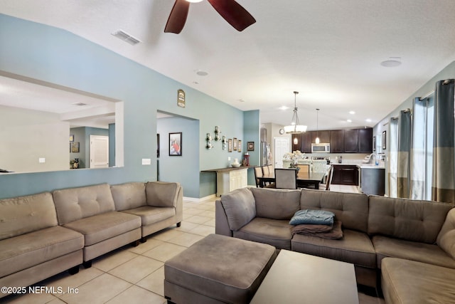 tiled living room featuring ceiling fan