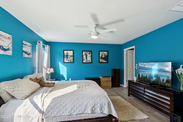 bedroom featuring ceiling fan and light hardwood / wood-style floors