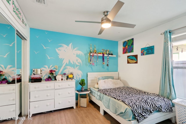 bedroom with ceiling fan and light hardwood / wood-style flooring