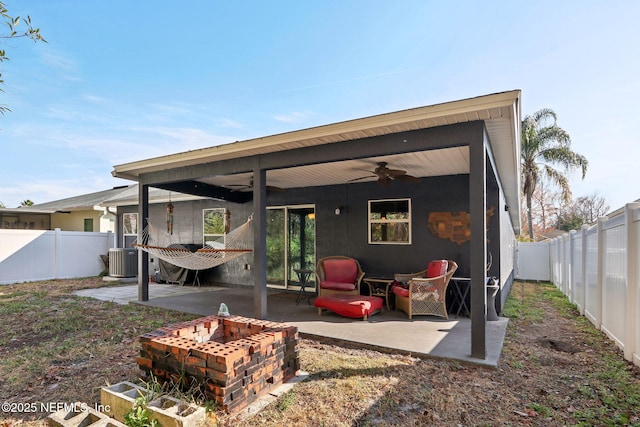 rear view of property with a patio, central AC unit, ceiling fan, and a fire pit