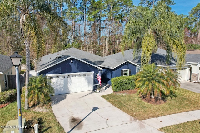 view of front of home featuring a garage and a front yard