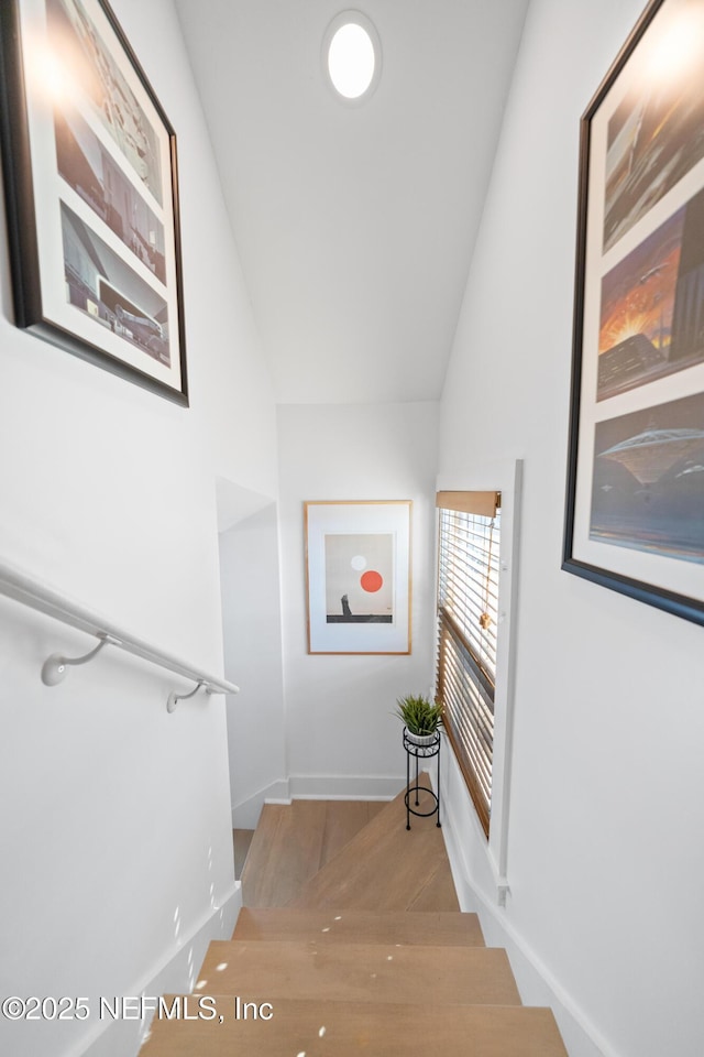 hall featuring vaulted ceiling