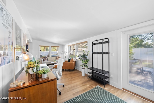 home office with lofted ceiling and hardwood / wood-style floors