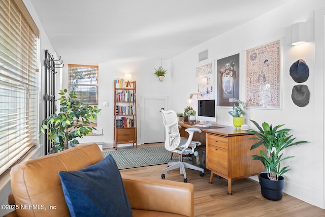 home office with wood-type flooring