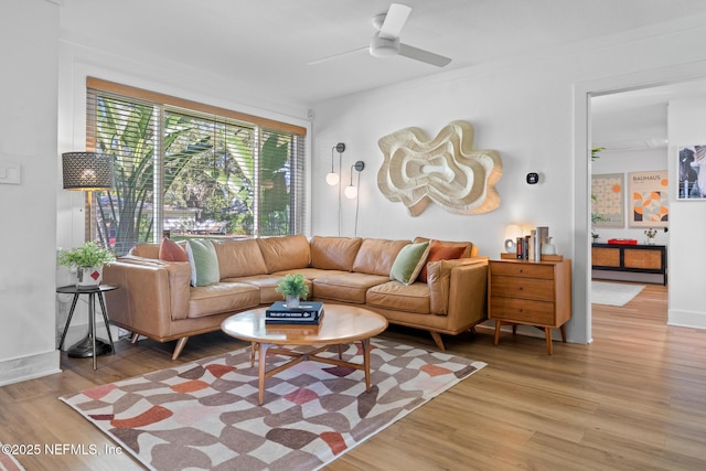 living room featuring ceiling fan and light wood-type flooring