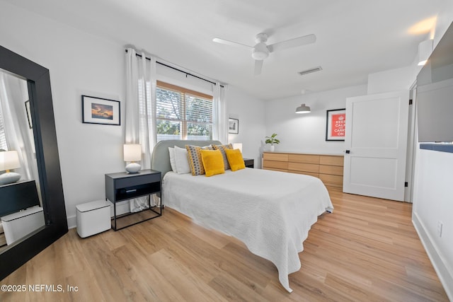 bedroom with ceiling fan and light hardwood / wood-style floors