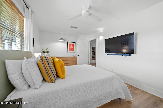 bedroom with hardwood / wood-style flooring and ceiling fan