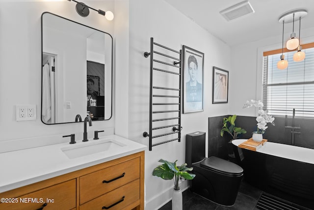 bathroom featuring vanity, toilet, and a bath