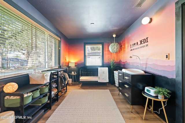 interior space with hardwood / wood-style flooring and radiator heating unit