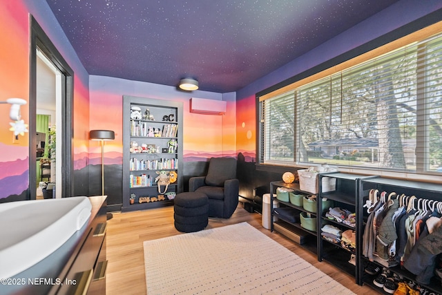 interior space featuring multiple windows, wood-type flooring, and a wall unit AC