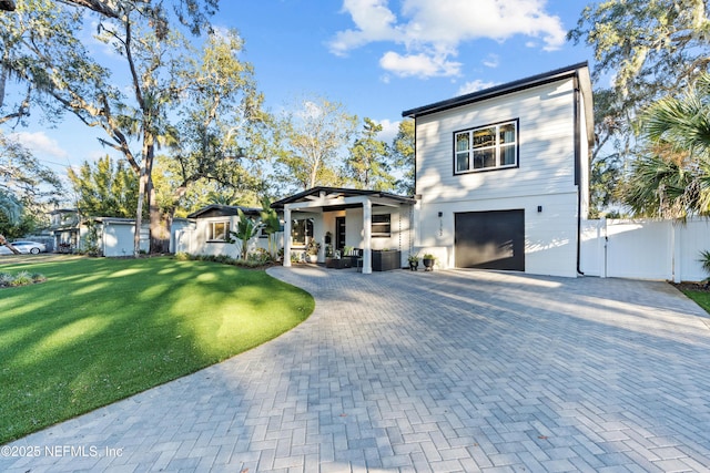 view of front of house with a garage and a front yard