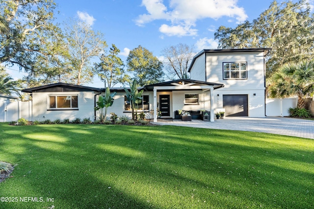 view of front of home featuring a garage and a front yard