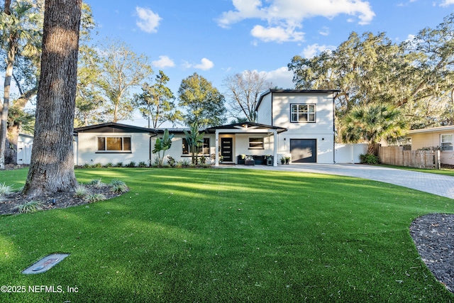 view of front of property featuring a garage and a front lawn