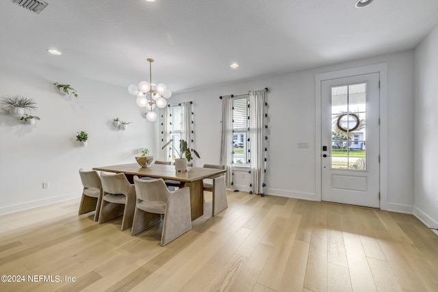 dining space featuring a notable chandelier and light hardwood / wood-style flooring