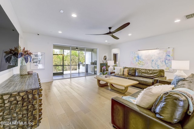 living room featuring ceiling fan and light hardwood / wood-style flooring