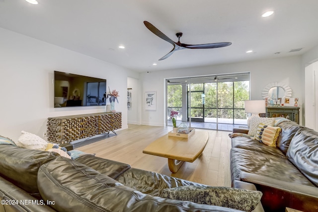 living room with ceiling fan and light wood-type flooring