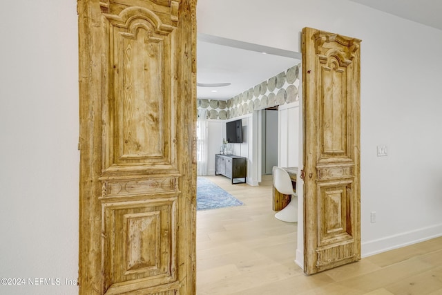 corridor featuring ornate columns and hardwood / wood-style floors