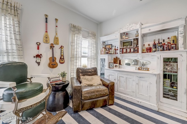 sitting room featuring bar area