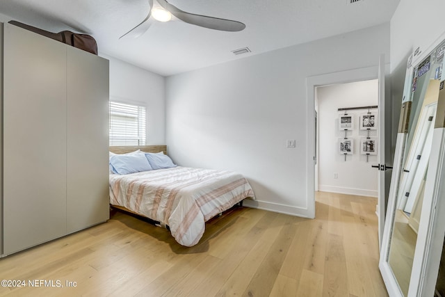 bedroom with wood-type flooring and ceiling fan