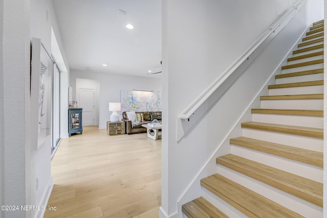 stairway with hardwood / wood-style flooring