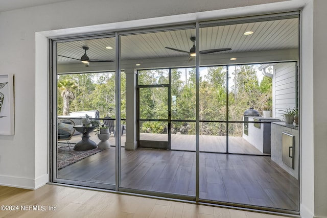 entryway with ceiling fan, a wealth of natural light, and light wood-type flooring