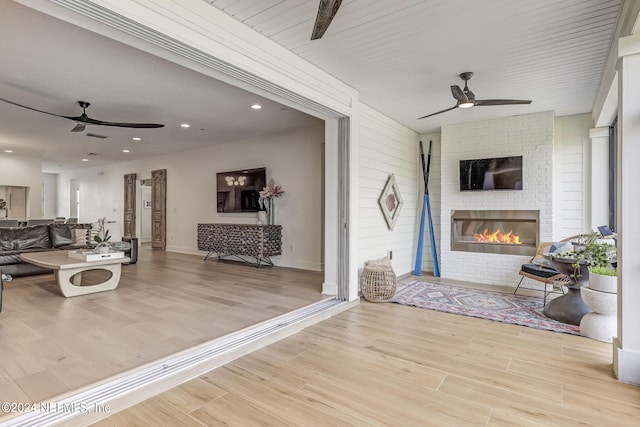 interior space featuring ceiling fan and a fireplace