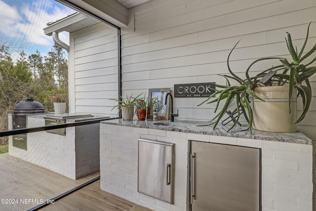 view of patio featuring area for grilling and sink