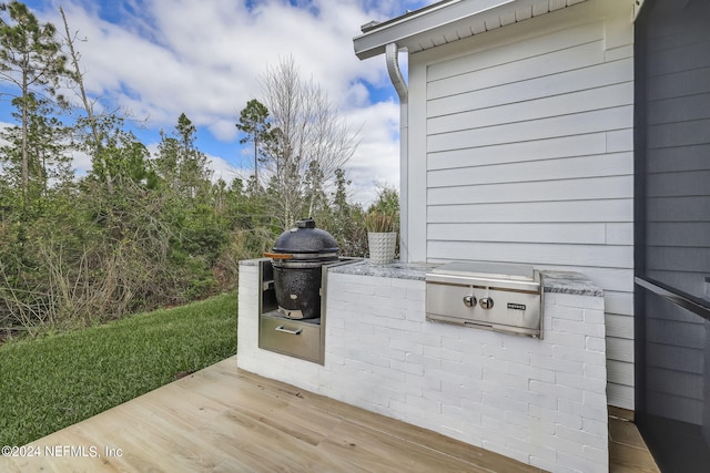 view of patio / terrace featuring a wooden deck and area for grilling