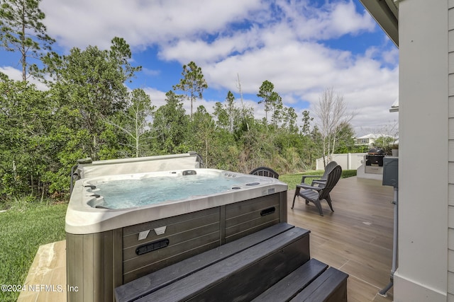 wooden deck featuring a hot tub