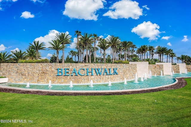 community sign featuring a lawn