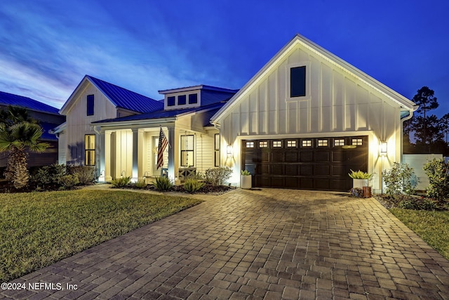 view of front of property featuring a yard and a garage