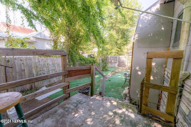 wooden terrace with a patio area