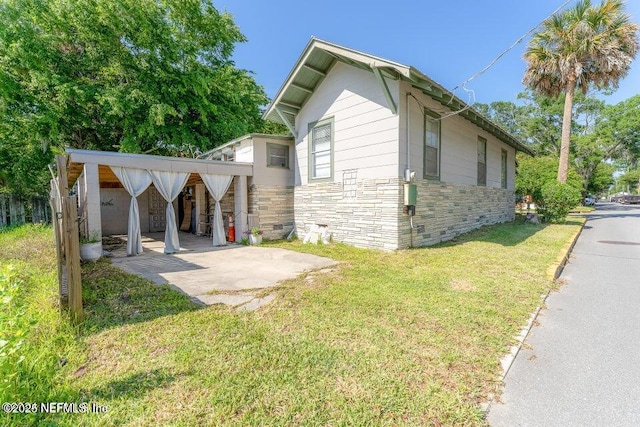 view of side of home featuring a yard