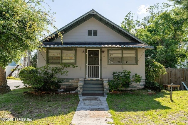 bungalow-style house with a front lawn