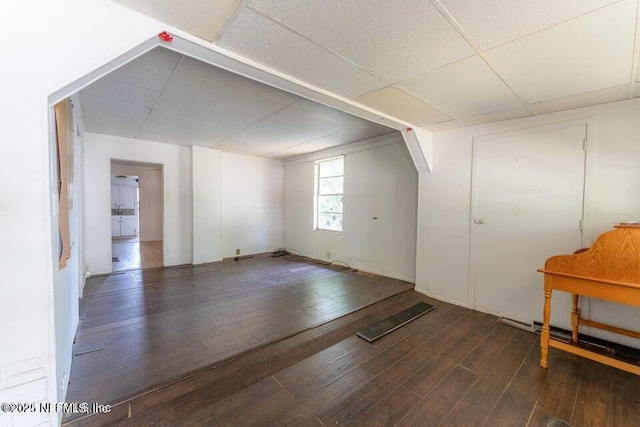 additional living space with dark wood-type flooring