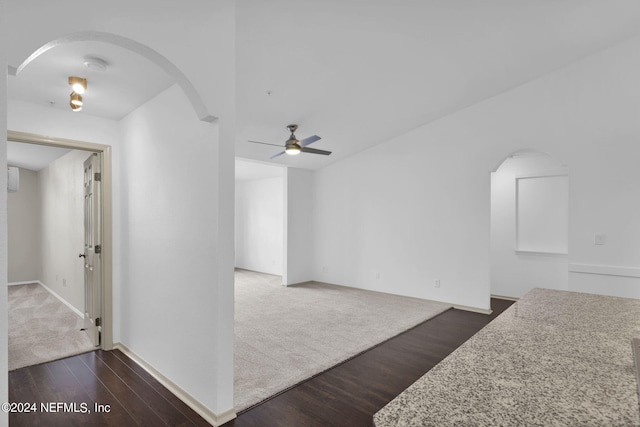 living room with dark wood-type flooring and ceiling fan