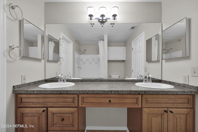 bathroom featuring vanity, toilet, and walk in shower