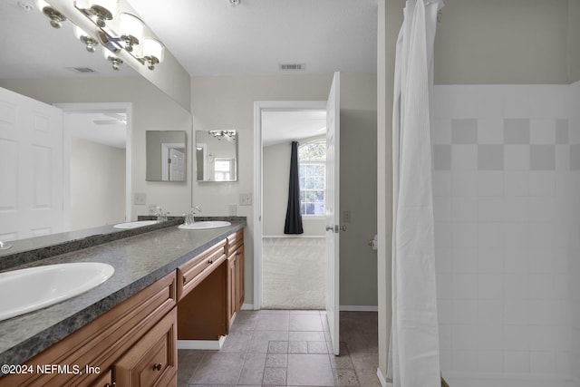 bathroom featuring tile patterned flooring and vanity