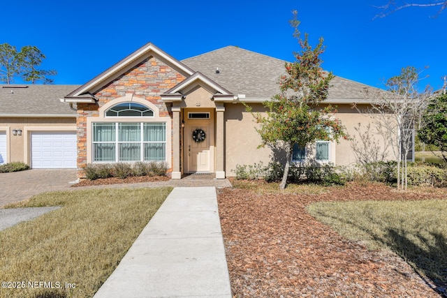 single story home with a garage and a front yard