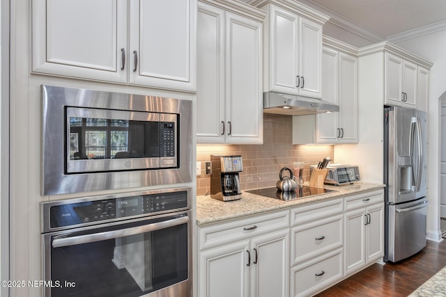 kitchen featuring backsplash, light stone countertops, white cabinets, and appliances with stainless steel finishes