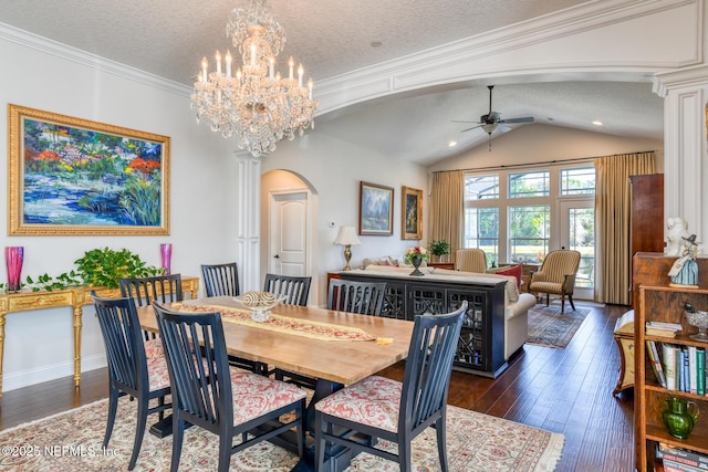 dining space featuring vaulted ceiling, dark hardwood / wood-style floors, ceiling fan with notable chandelier, and a textured ceiling