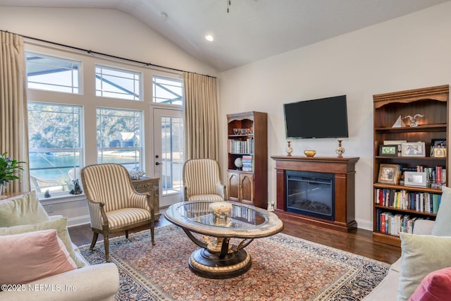 living room with dark wood-type flooring and vaulted ceiling