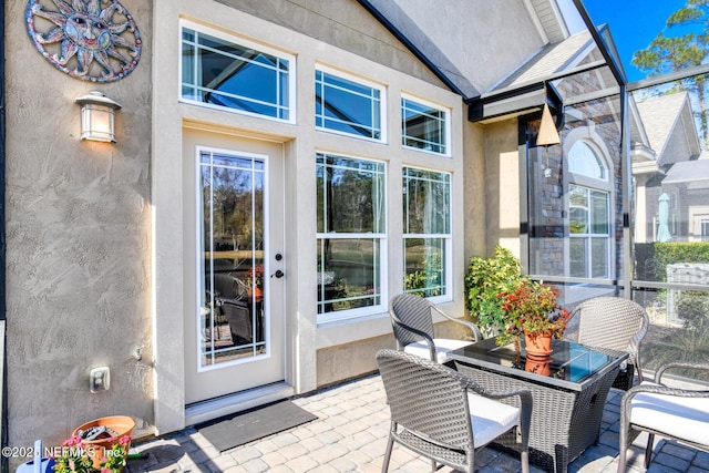 property entrance featuring a patio