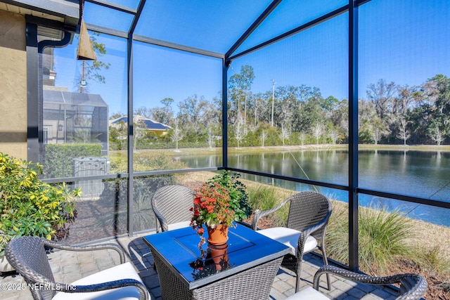 sunroom with a water view and lofted ceiling