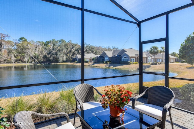 sunroom / solarium with a water view