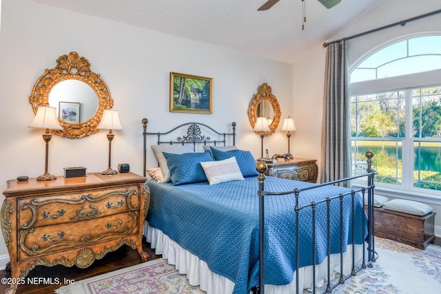 bedroom featuring hardwood / wood-style floors, a textured ceiling, vaulted ceiling, and ceiling fan